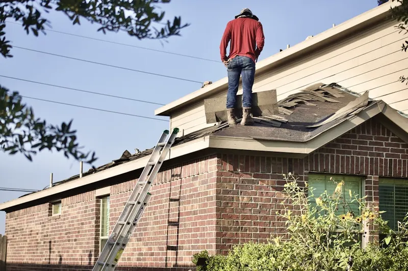 Professional roofer working on a residential roof in Redondo